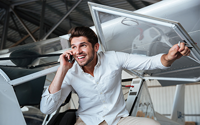 A man getting out of a cirrus aircraft