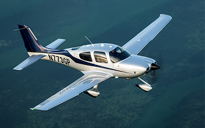 cirrus aircraft flying in the sky