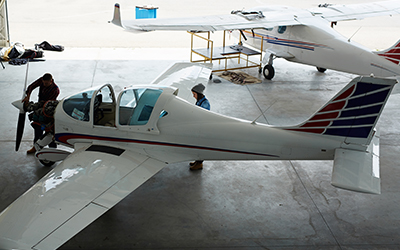 A man working on parts of an airplane