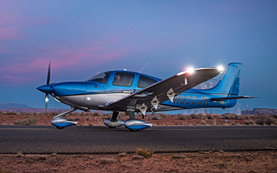 Cirrus aircraft on the runway at night