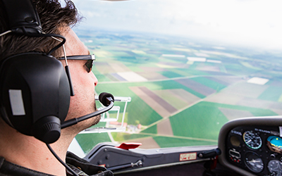 A man flying a cirrus aircraft