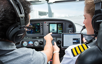 Two pilots discussing verbal callouts in the aircraft