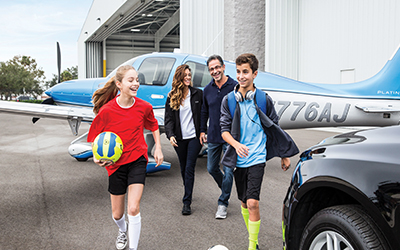 A family getting out of a private cirrus aircraft