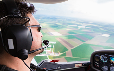 A male pilot flying his plane