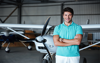 A man standing in front of a cirrus airplane